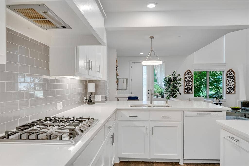 525 Division Street, Plano, TX 75075 Kitchen feature quartz, a built-in gas range, a stainless steel sink with a modern faucet, and a light gray tile backsplash