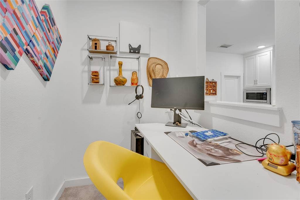 525 Division Street, Plano, TX 75075 Built-in desk with a white finish, featuring a pass-through window and recessed lighting in the adjacent space