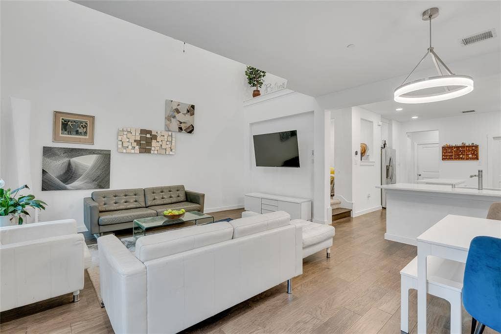 525 Division Street, Plano, TX 75075 Spacious open-concept living area with high ceilings, wood-finish flooring, and recessed lighting