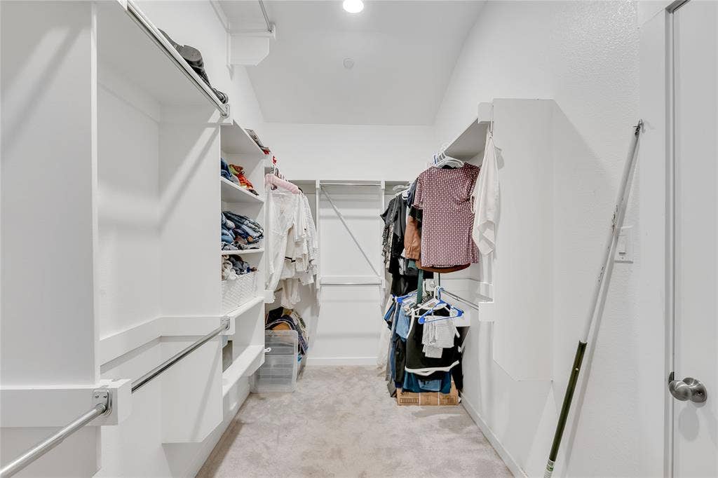 525 Division Street, Plano, TX 75075 Walk-in closet with built-in shelving, chrome hanging rods, and recessed lighting