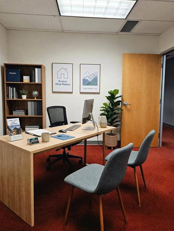 1675 Republic Parkway, #150 and 5 Offices, Mesquite, TX 75150 Light wood-finish desk with integrated modesty panel, red textured carpeting, and a built-in wood-finish bookcase