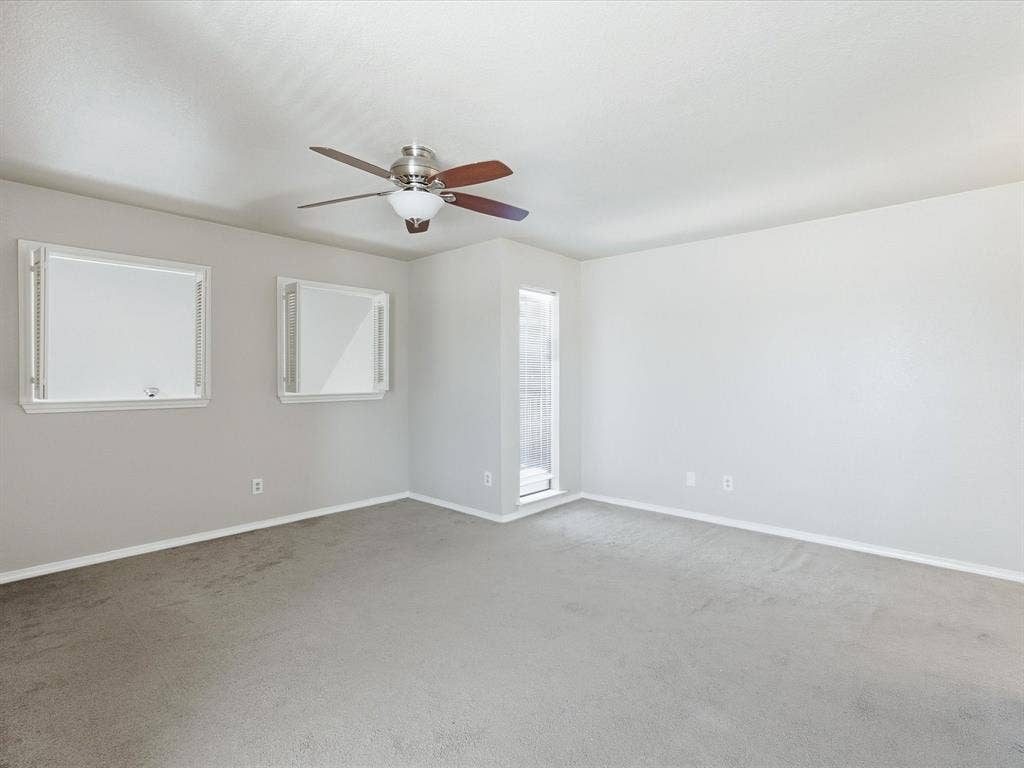3129 Sondra Drive, #206, Fort Worth, TX 76107 Ceiling fan with light fixture, neutral carpet flooring, and multiple windows