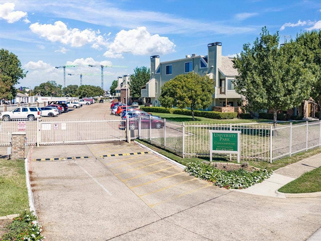 3129 Sondra Drive, #206, Fort Worth, TX 76107 Gated entry with brick pillar accents and a paved drive leading to surface parking