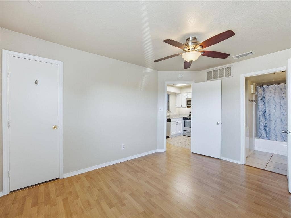 3129 Sondra Drive, #206, Fort Worth, TX 76107 Wood-finish flooring with a ceiling fan light fixture