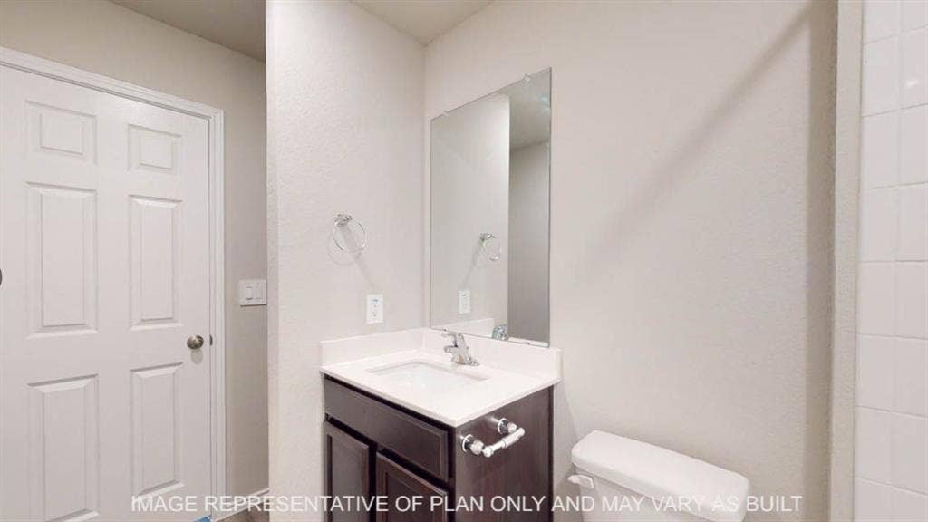 10108 Altair Drive, Waco, TX 76708 Vanity with dark wood-finish cabinetry, white countertop, and integrated sink