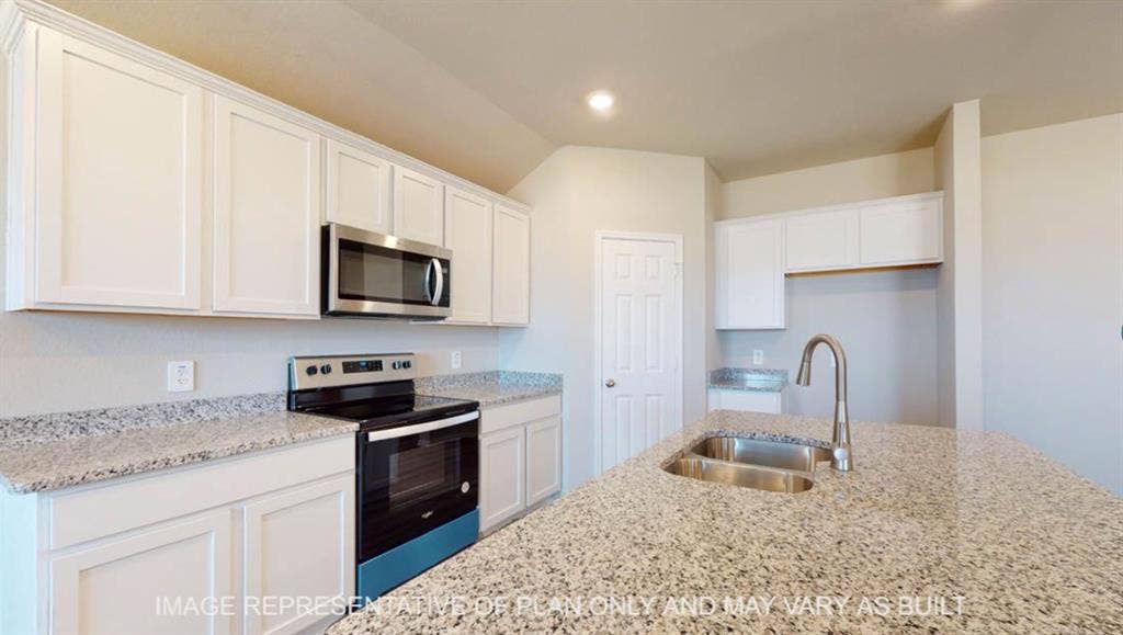 10108 Altair Drive, Waco, TX 76708 Spacious kitchen featuring white cabinetry, stainless steel appliances, granite countertops, and a dual-basin sink with a gooseneck faucet