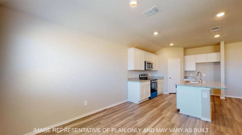 10108 Altair Drive, Waco, TX 76708 Wood-finish flooring throughout, white cabinetry, integrated stainless steel microwave, and recessed lighting
