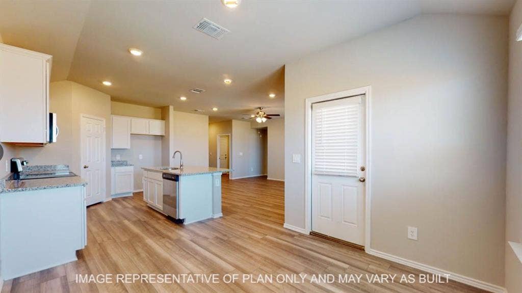 10108 Altair Drive, Waco, TX 76708 Open-concept interior featuring wood-finish flooring, recessed lighting, and a kitchen island with a stainless steel sink and appliances
