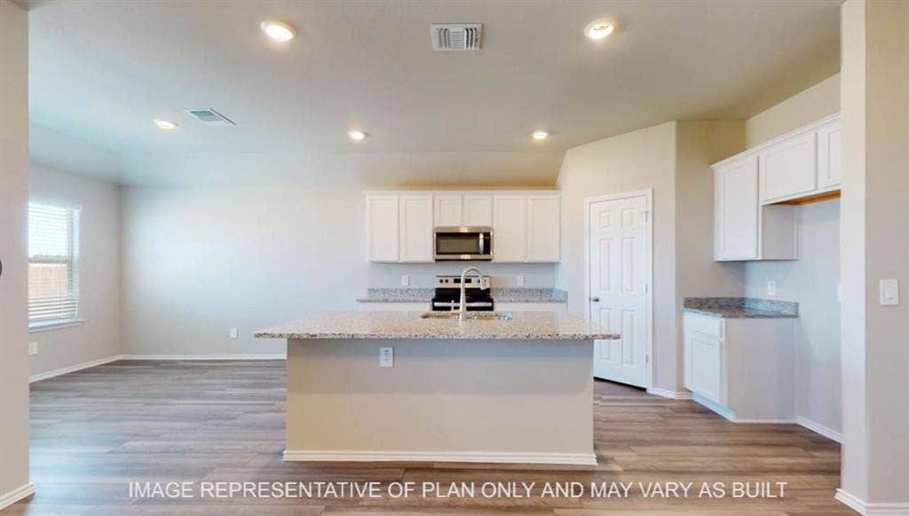 10108 Altair Drive, Waco, TX 76708 Open-concept kitchen with a central island, recessed lighting, stainless steel appliances, white cabinetry, and light-toned countertops