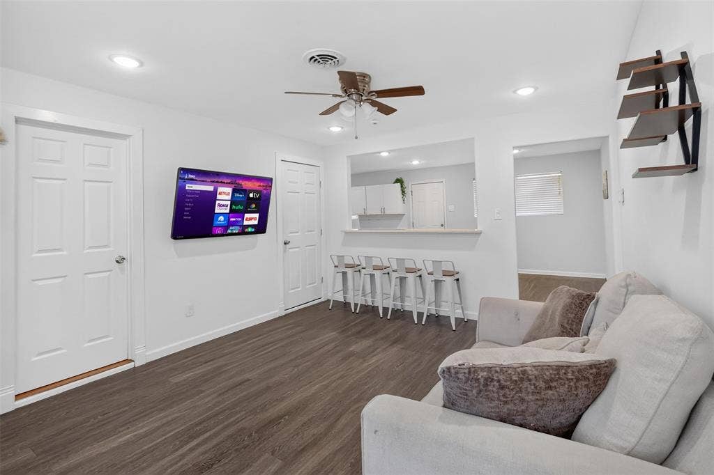 Updated living room with recessed lighting.