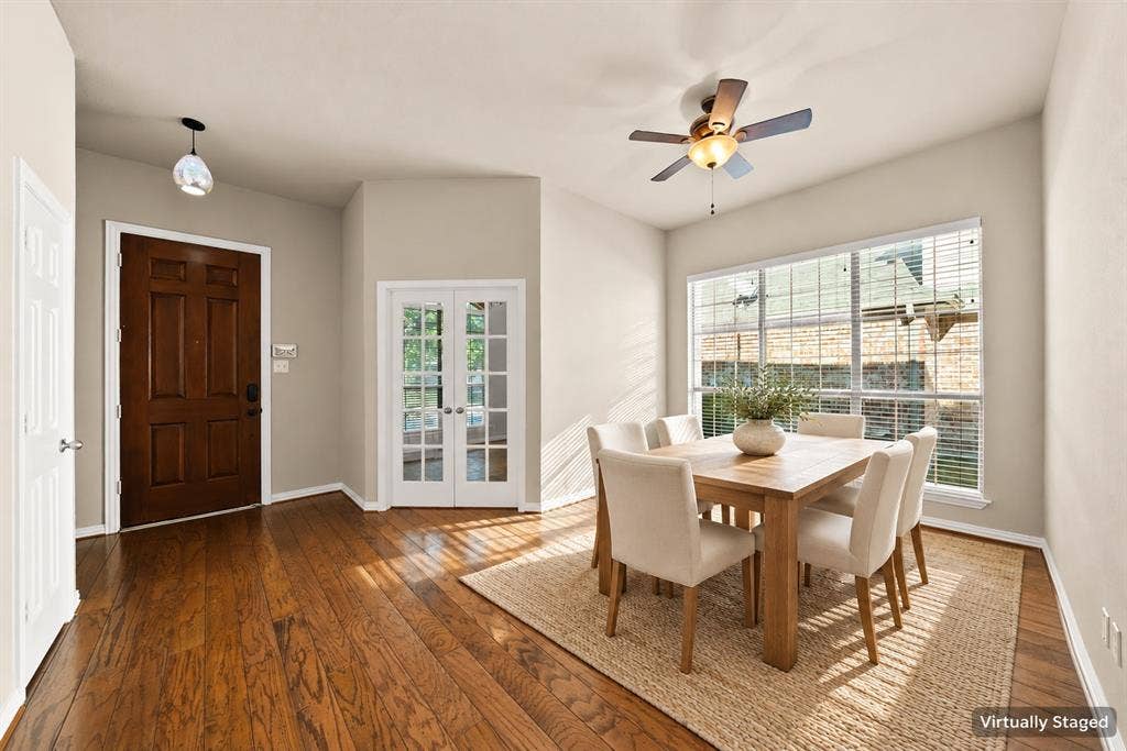 242 Cox Drive, Fate, TX 75087 Wood-finish flooring throughout, a six-panel solid wood entry door, and French paneled doors
