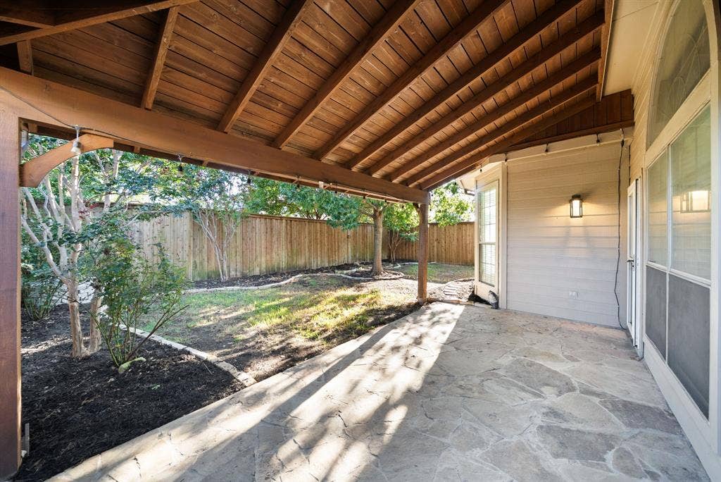 242 Cox Drive, Fate, TX 75087 Covered patio with a natural stone-look surface, wood plank ceiling, and recessed lighting