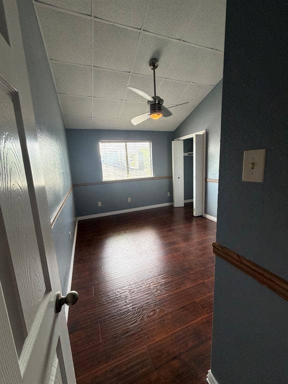 2200 W Park Boulevard, #1003, Plano, TX 75075 Bed Room two upstairs featuring vaulted ceilings, wood-finish flooring, a ceiling fan with integrated lighting, and a closet with bifold doors