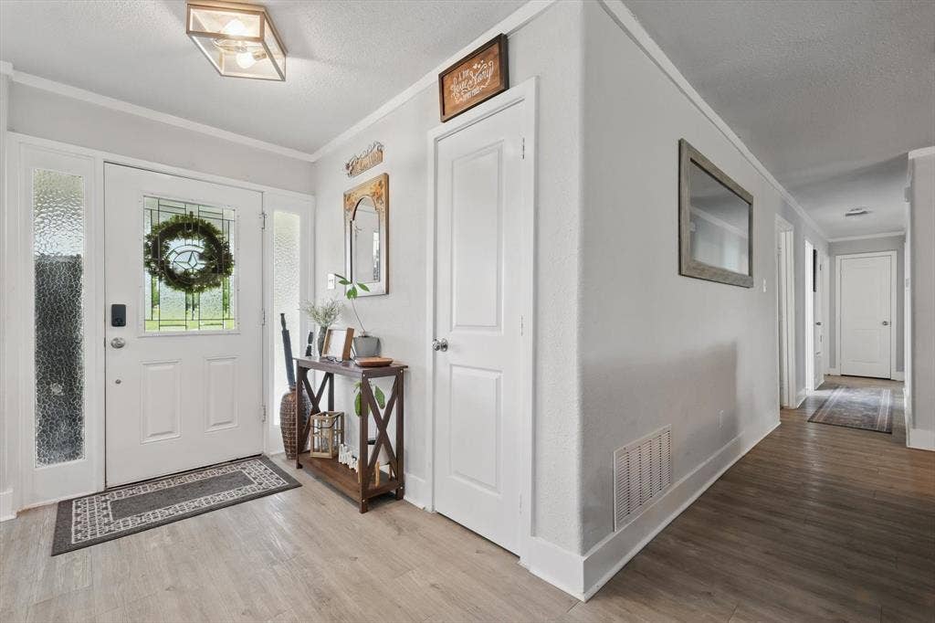 5247 Fm 1569, Farmersville, TX 75442 Entryway featuring wood-finish flooring, white paneled doors, and a decorative glass front door with sidelights