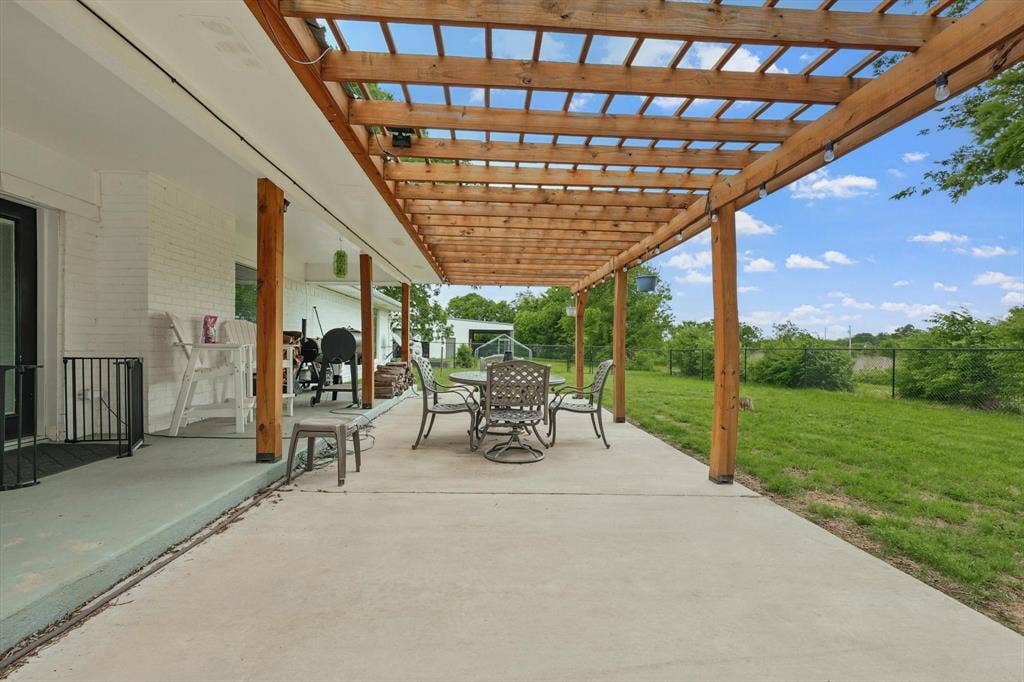 5247 Fm 1569, Farmersville, TX 75442 Expansive concrete patio with a wooden pergola