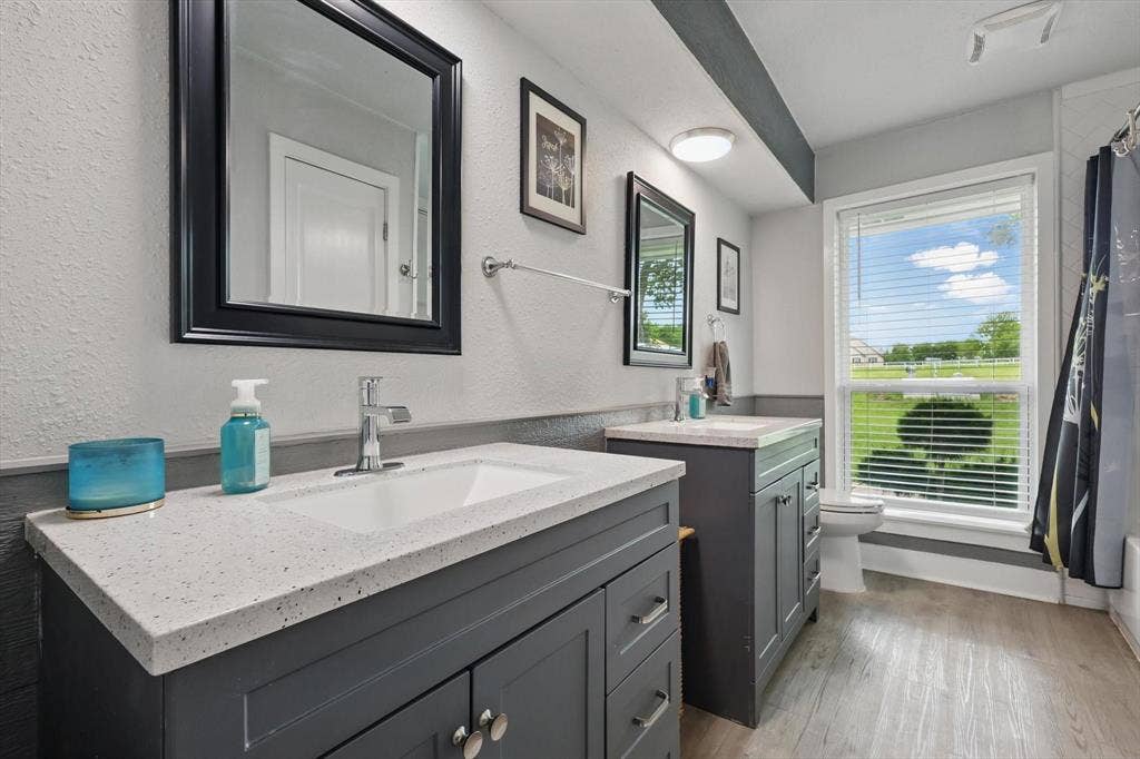 5247 Fm 1569, Farmersville, TX 75442 Dual vanities with integrated sinks, light-toned countertops, and dark cabinetry