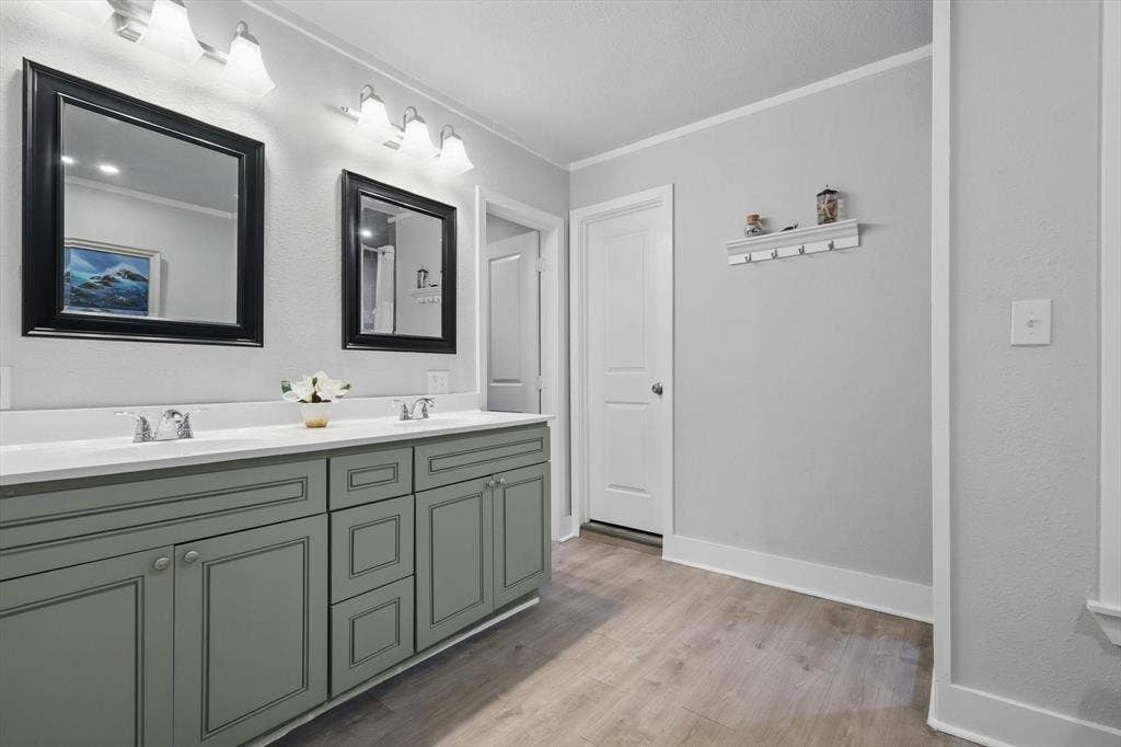 5247 Fm 1569, Farmersville, TX 75442 Double vanity with dual undermount sinks, gray shaker-style cabinetry, and wood-finish flooring