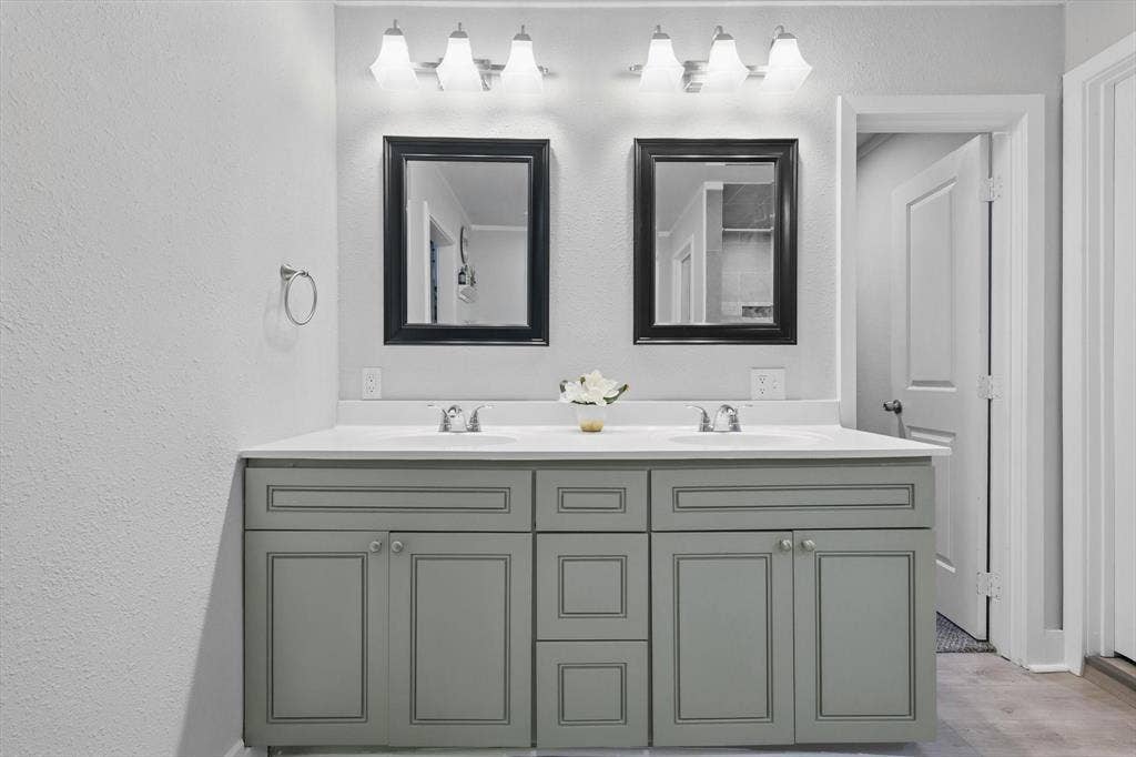 5247 Fm 1569, Farmersville, TX 75442 Dual-sink vanity with soft-close cabinetry in sage-finish wood, white quartz countertop, and polished chrome fixtures