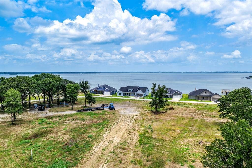 200 Caro Drive, West Tawakoni, TX 75454 Expansive waterfront parcel featuring mature trees, native vegetation, and direct shoreline frontage