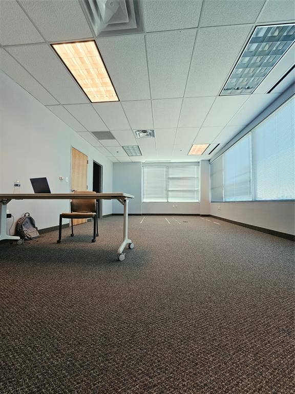 1675 Republic Parkway, #201B, Mesquite, TX 75150 Spacious room featuring textured carpet, multiple windows with blinds, recessed lighting, and a suspended ceiling