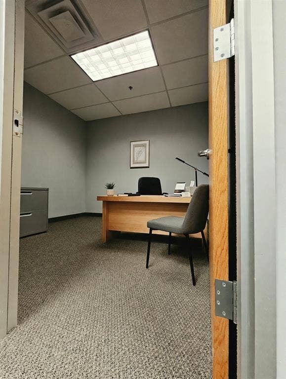 1675 Republic Parkway, #201B, Mesquite, TX 75150 Textured carpet flooring, suspended ceiling with recessed lighting, light wood-finish door, and light gray wall paint