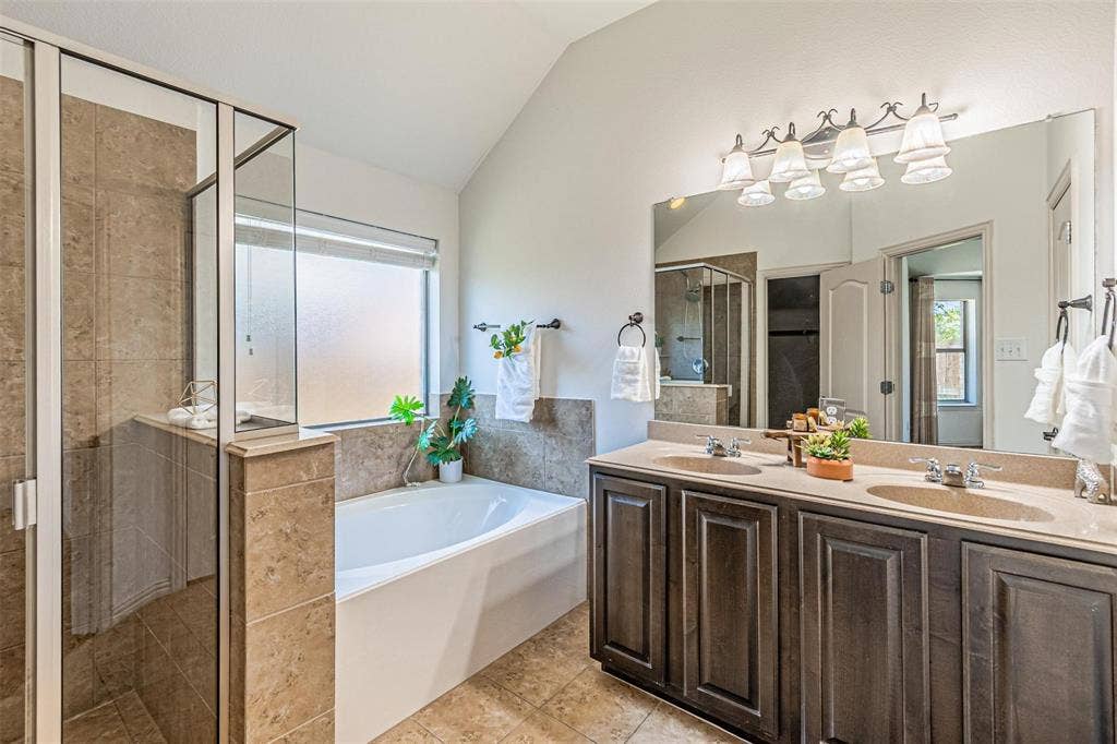 Dual vanity with stone-finish countertop and dark wood-finish cabinetry