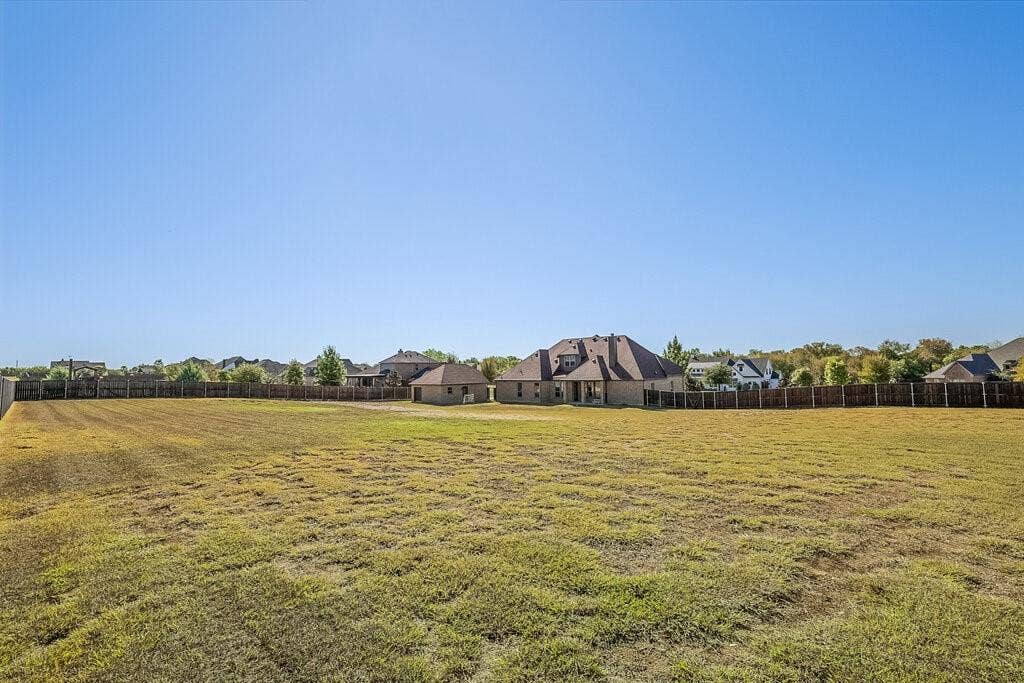 Expansive undeveloped lot with perimeter fencing