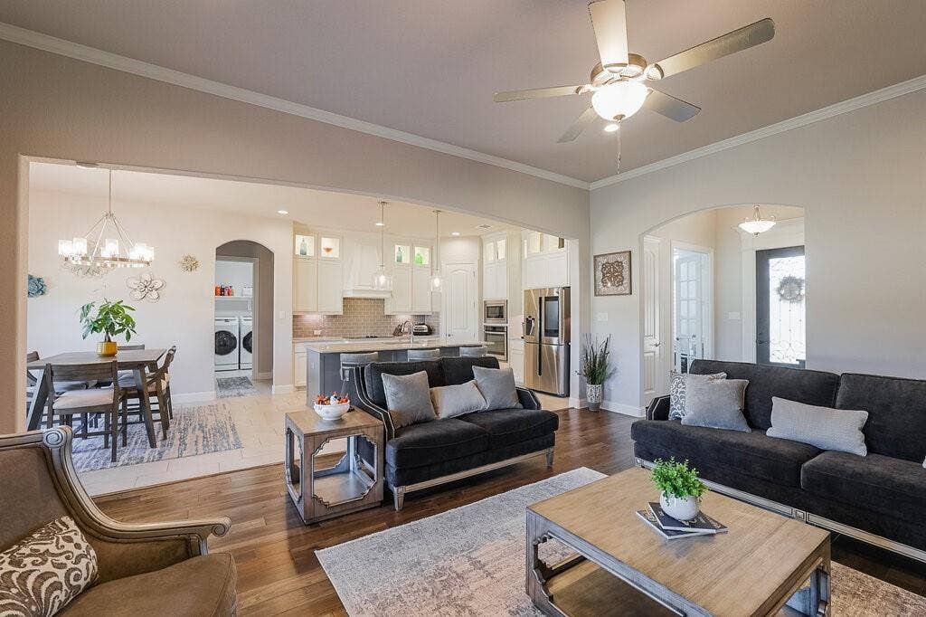 Hardwood-finish flooring, recessed lighting, ceiling fan, arched doorway, and built-in stainless steel appliances