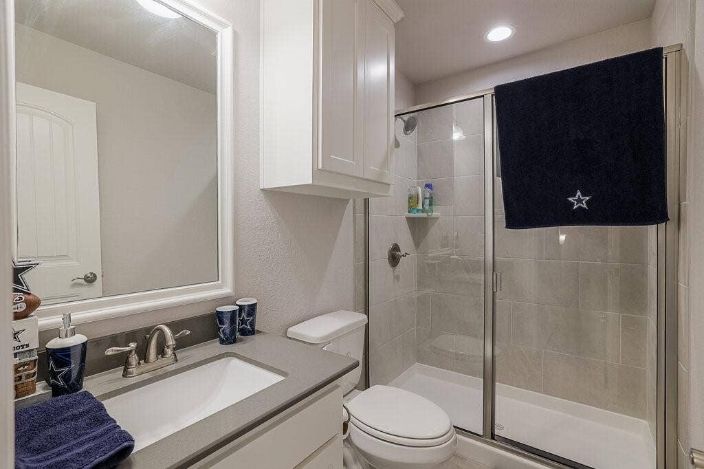 Vanity with an integrated rectangular sink, gray countertop, and brushed nickel faucet