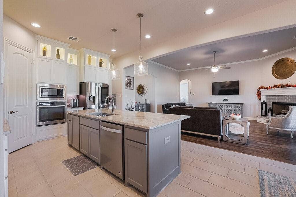 Kitchen island with an undermount sink and pendant lighting