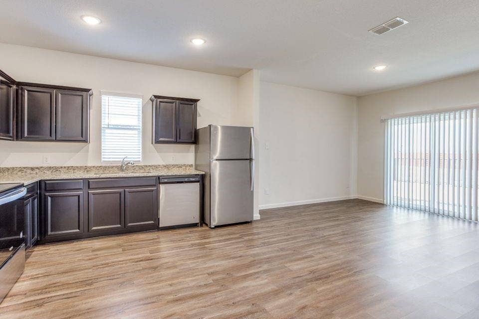 212 Briar Cove, Anna, TX 75409 Open-concept living area featuring wood-finish flooring, recessed lighting, and a sliding glass door