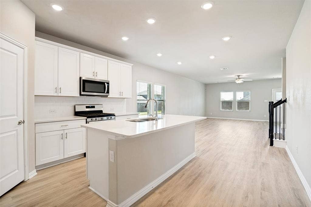 Open-concept living space with wood-finish flooring