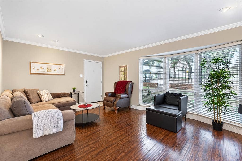 5005 Cedar Springs Road, #A, Dallas, TX 75235 Wood-finish flooring, recessed lighting, crown molding, a bay window, and a white entry door