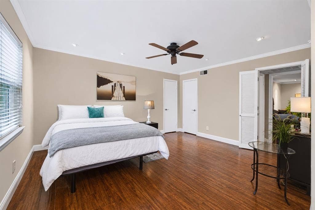 5005 Cedar Springs Road, #A, Dallas, TX 75235 Recessed lighting, wood-finish flooring, white window blinds, white interior doors, and a ceiling fan with light