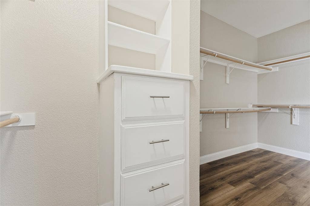 Oversized walk-in primary closet that wraps all the way around