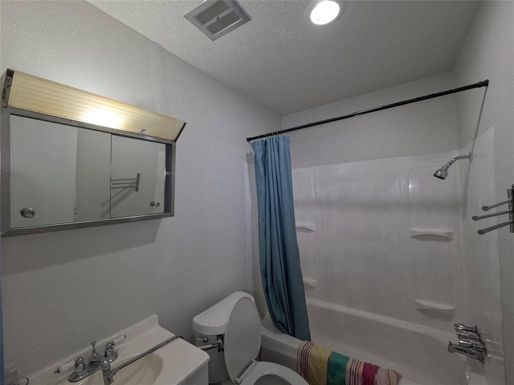 21 W Townhouse Lane, #33, Grand Prairie, TX 75052 White bathtub with integrated shelving, chrome showerhead, and wall-mounted towel bars