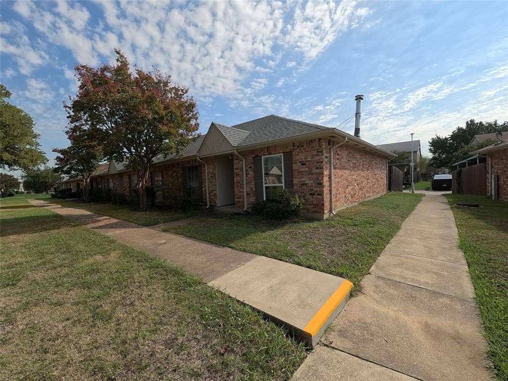 21 W Townhouse Lane, #33, Grand Prairie, TX 75052 Brick exterior with a gabled roof and white trim