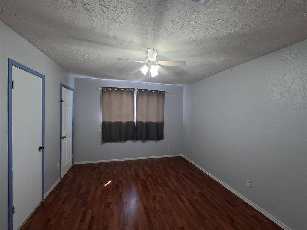 21 W Townhouse Lane, #33, Grand Prairie, TX 75052 Wood-finish flooring throughout, light gray wall finishes, and a ceiling fan with integrated lighting