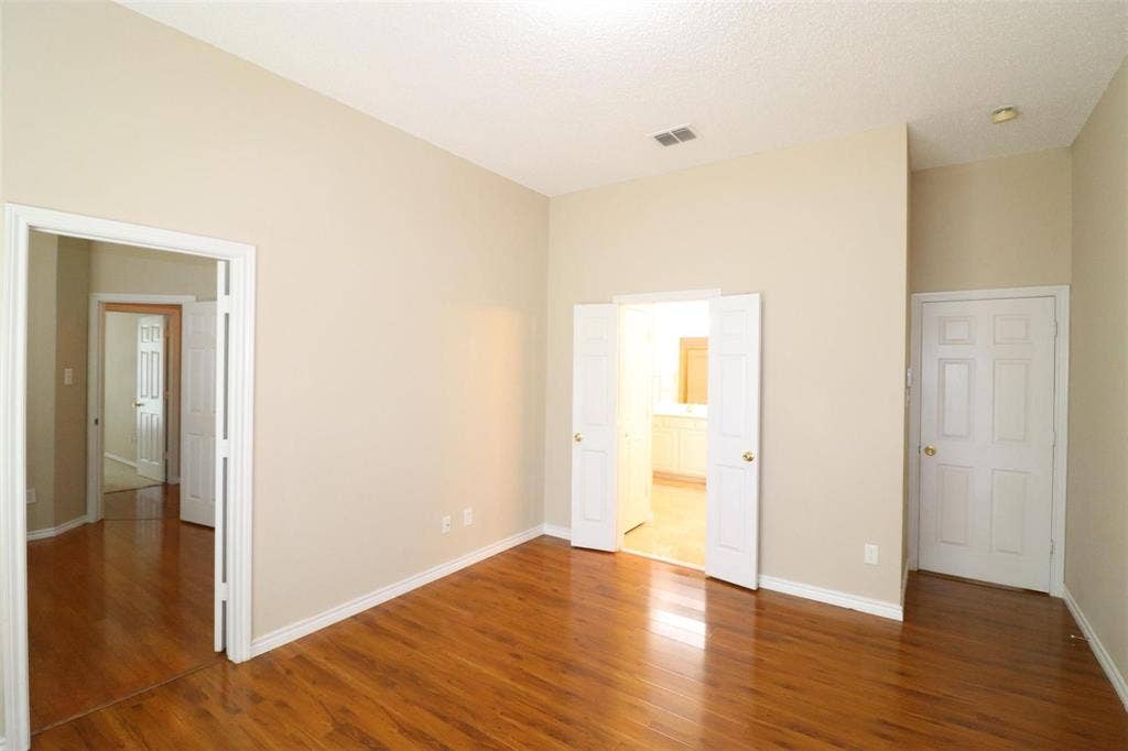 2222 Edinburgh Way, Garland, TX 75040 Wood-finish flooring, neutral wall tones, recessed ceiling lighting, and multiple paneled doors