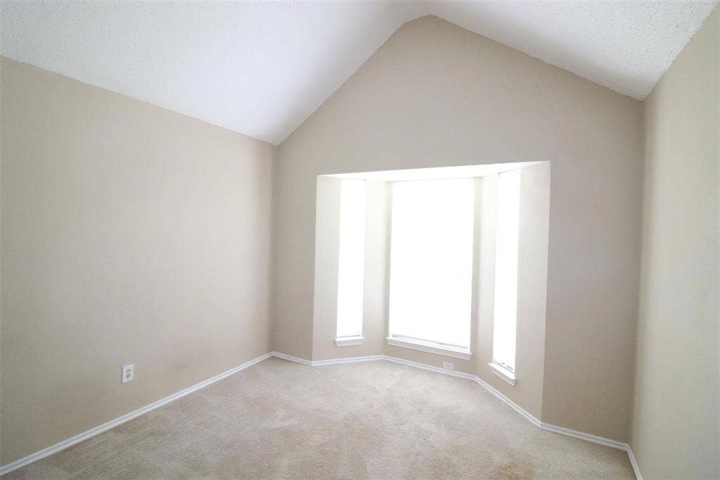 2222 Edinburgh Way, Garland, TX 75040 Vaulted ceiling with an integrated bay window and neutral carpeting