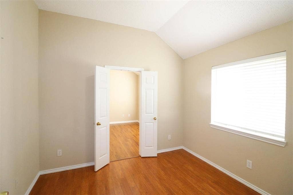 2222 Edinburgh Way, Garland, TX 75040 Vaulted ceiling, wood-finish flooring, and white trim