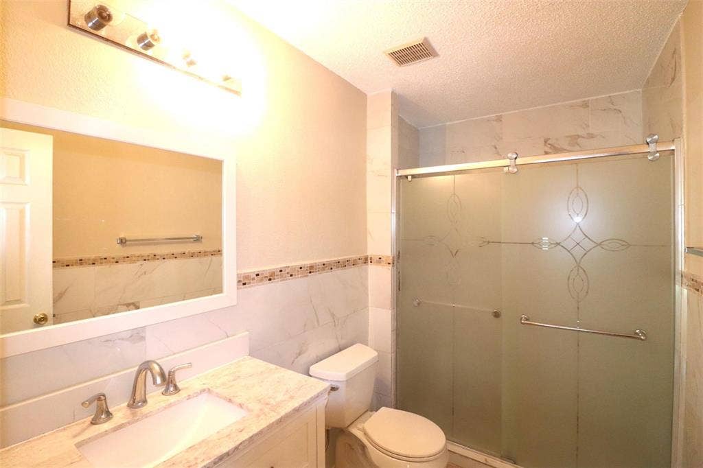 2222 Edinburgh Way, Garland, TX 75040 Vanity with a polished countertop and undermount sink