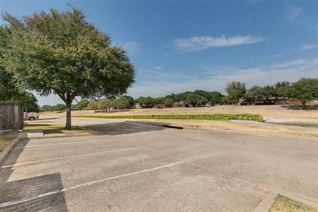 2111 E Belt Line Road, #158B, Richardson, TX 75081 Paved parking area with marked spaces and curb delineation