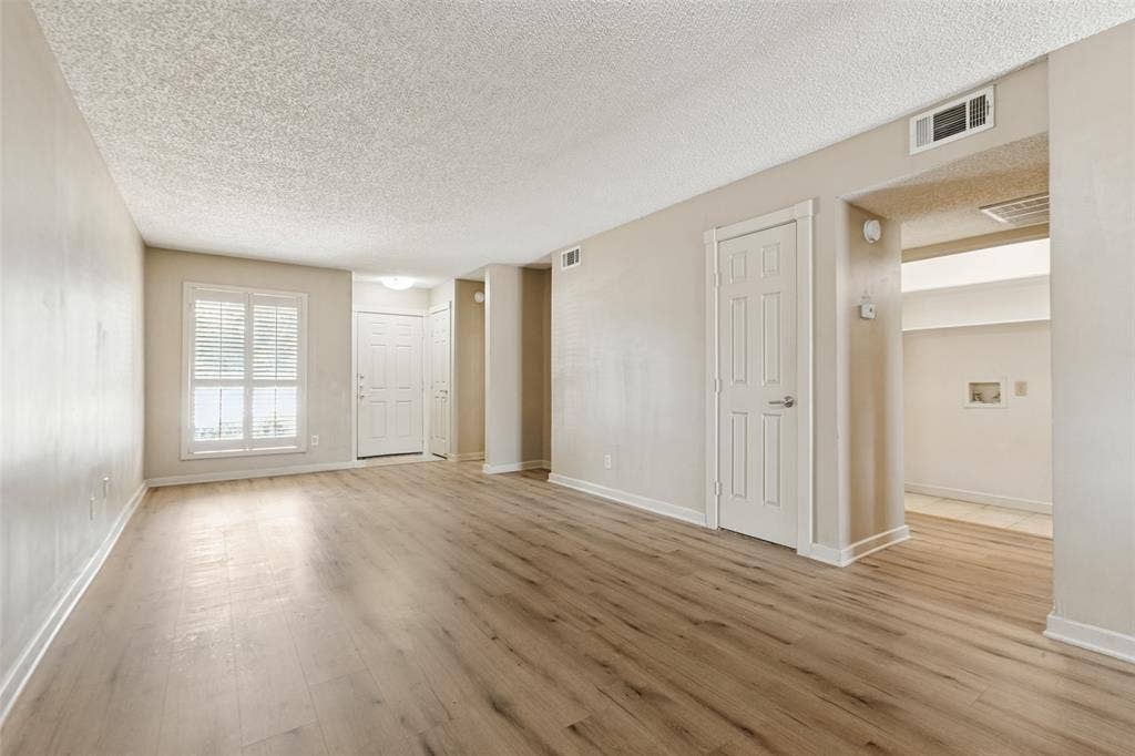 2111 E Belt Line Road, #158B, Richardson, TX 75081 Wood-finish flooring throughout, neutral wall tones, and white trim