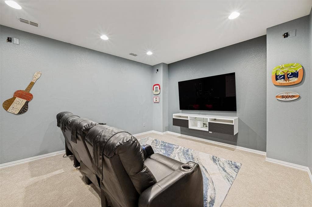 131 Darian Drive, Prosper, TX 75078 Recessed ceiling lighting illuminates a media wall featuring a mounted television and a floating entertainment console