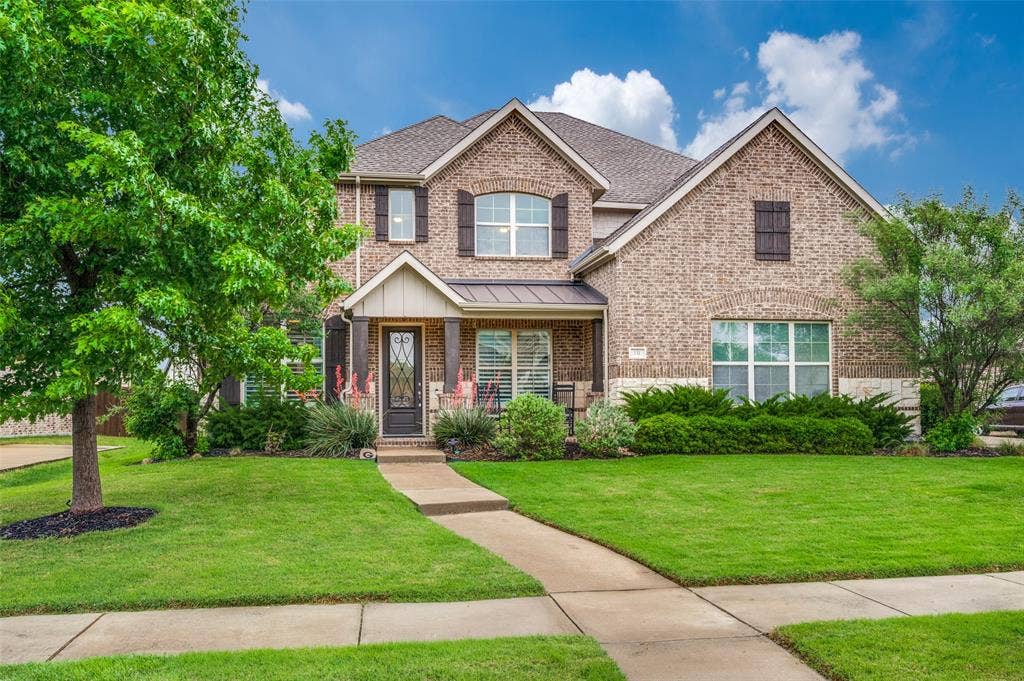 131 Darian Drive, Prosper, TX 75078 Brick exterior with stone accents and dark shutters