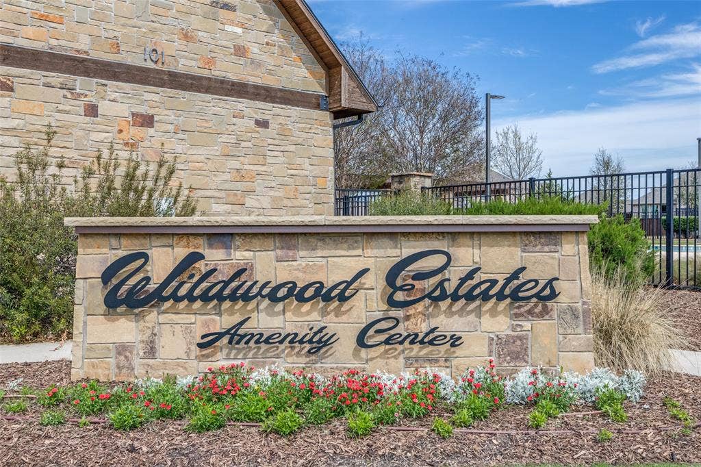 131 Darian Drive, Prosper, TX 75078 Stone-clad amenity center sign featuring dimensional lettering, low-profile landscaping, and stone masonry construction