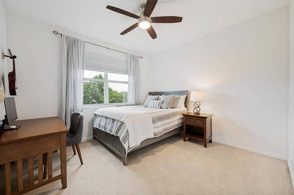 131 Darian Drive, Prosper, TX 75078 Recessed window with white trim, light-colored carpeting, and a ceiling fan with light fixture