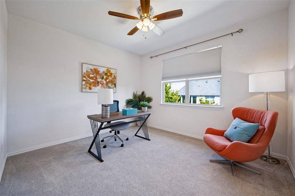 131 Darian Drive, Prosper, TX 75078 Neutral-toned carpeted room featuring a ceiling fan with integrated lighting, window with a roller shade, and drapery hardware