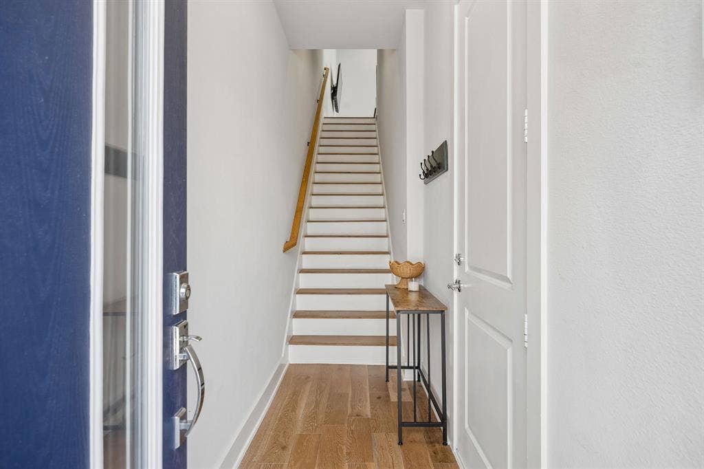 381 E Greenbriar Lane, #1001, Dallas, TX 75203 A beautiful front entryway greets you with warm engineered hardwoods sharing access to your private 2-car tandem garage.
